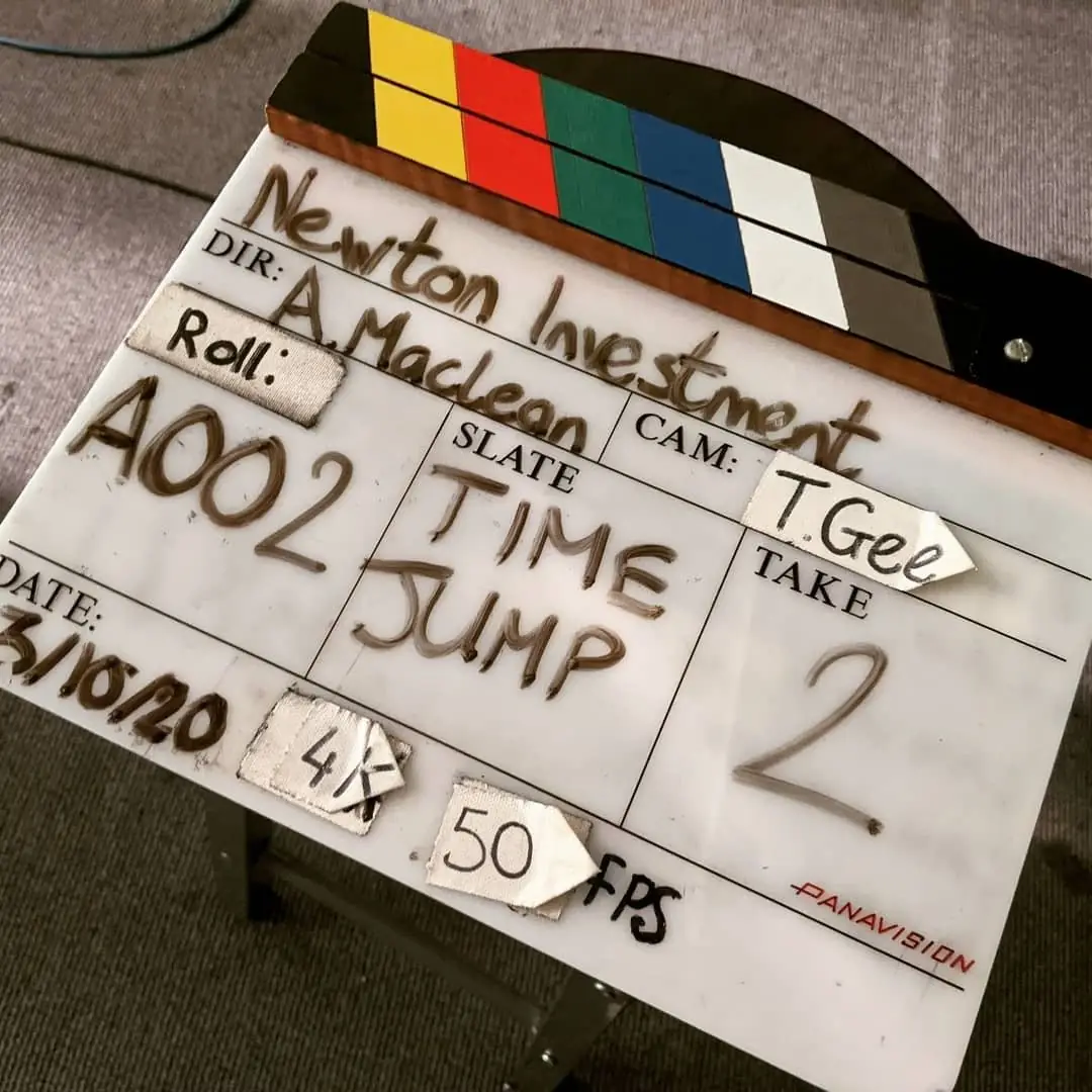 A hand-written clapperboard reading Newton Investment, director A Maclean, roll A002, scene Time Jump, take 2